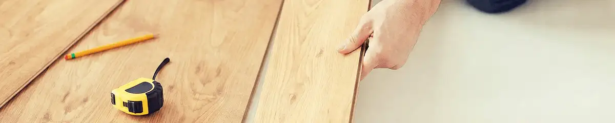 A professional installing wood flooring in San Jose, CA