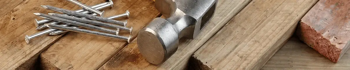 Hammer and nails on hardwood flooring boards in San Jose, CA